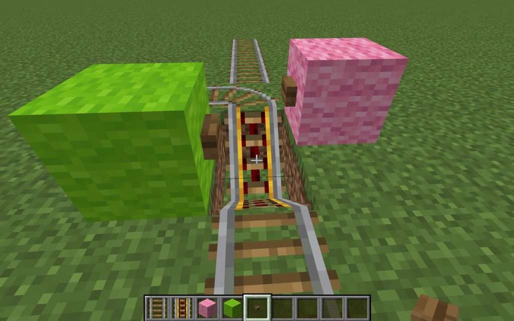 Place two buttons with different color wool behind them in your Minecraft Railroad Switch so that players can distingush between which button activates the switch